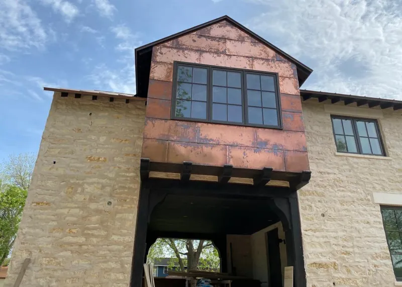 Copper metal panel facade on a stone building for Skylight Installation in Arlington Heights