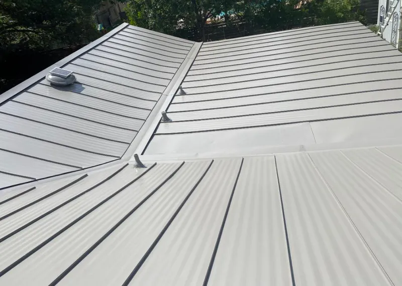 Solar attic fan installed on a metal roof for Roof Ventilation in Arlington Heights